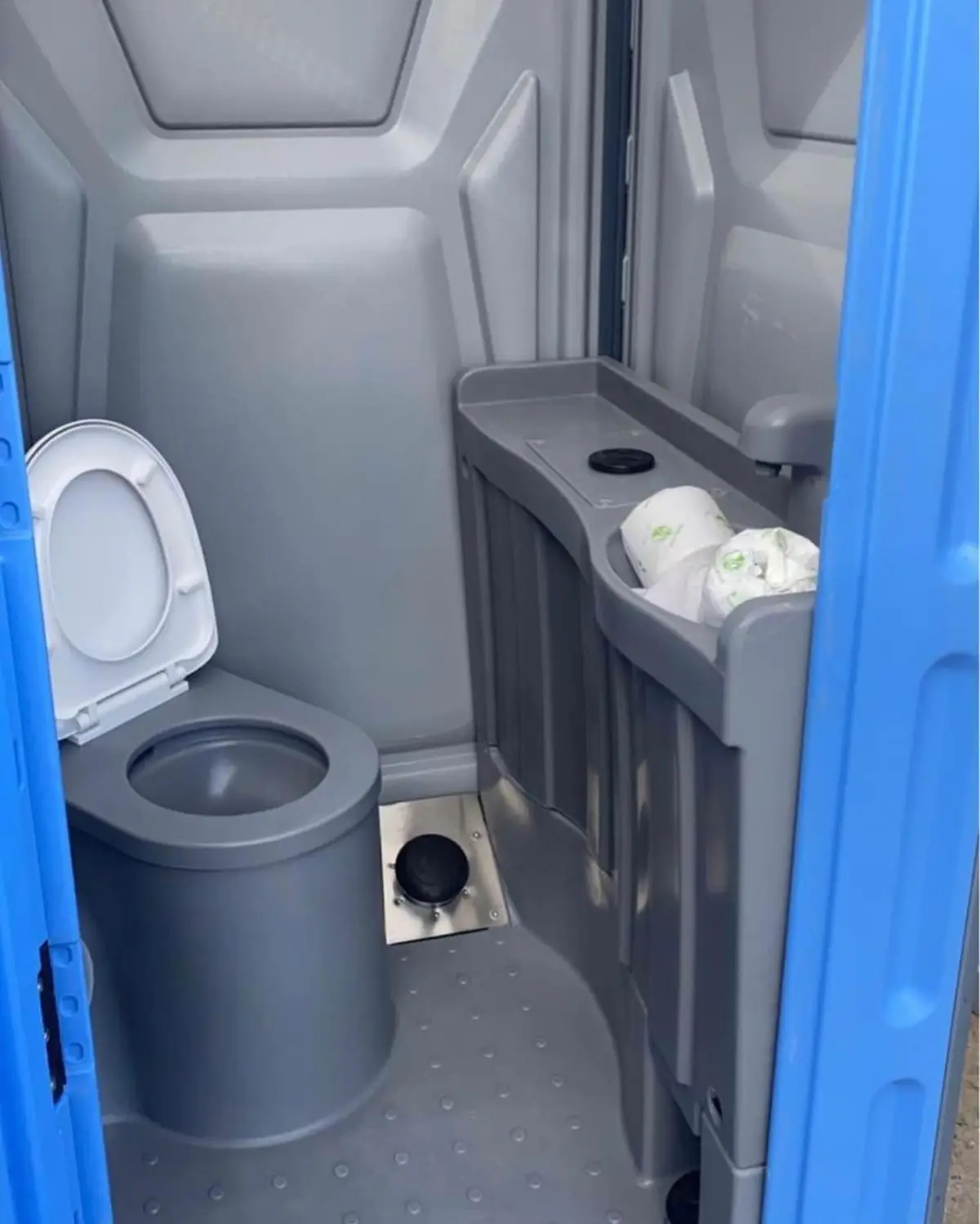 Inside a deluxe unit with a foot-pump sink and mirror
