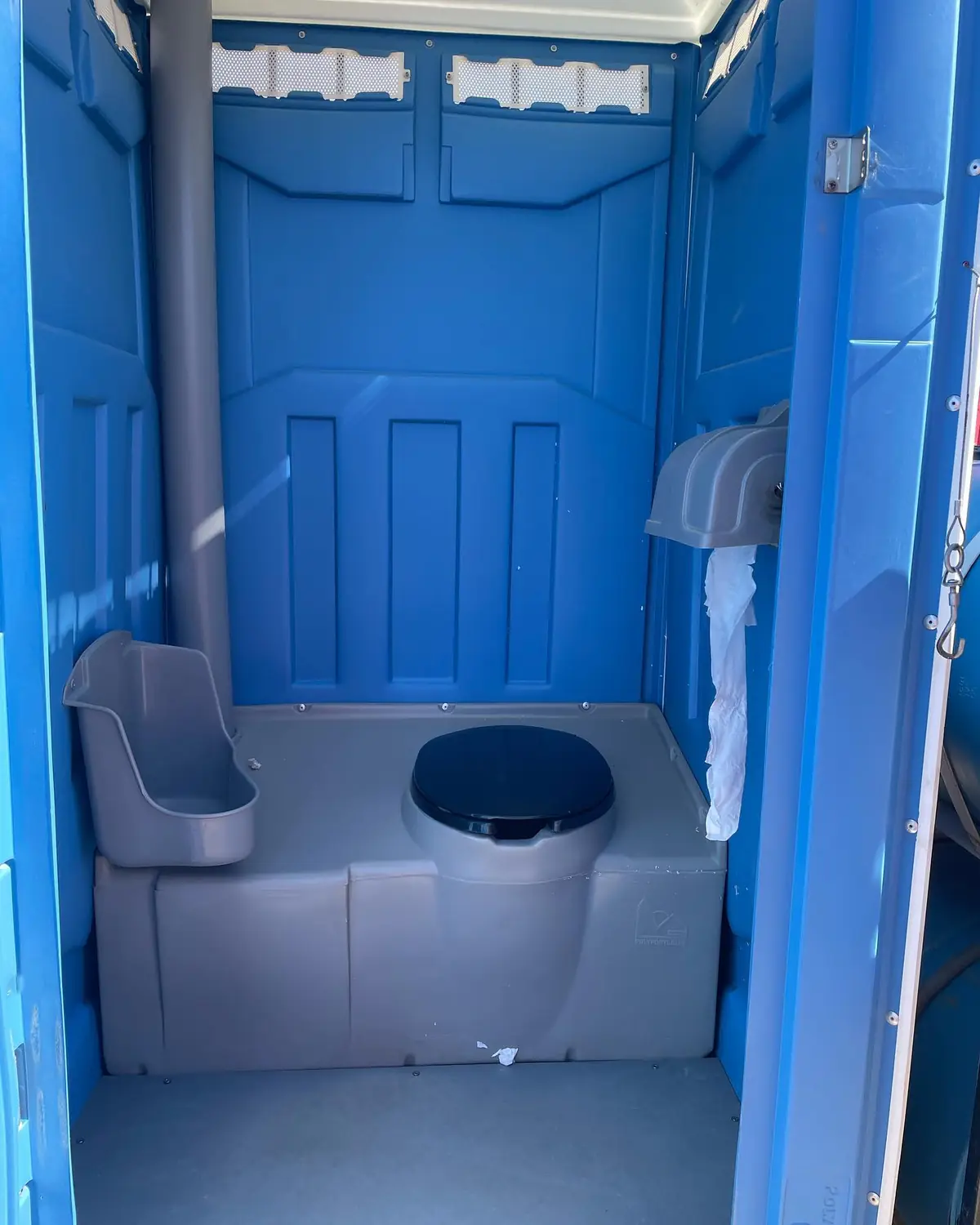 Interior of a standard unit showing the urinal beside the toilet seat