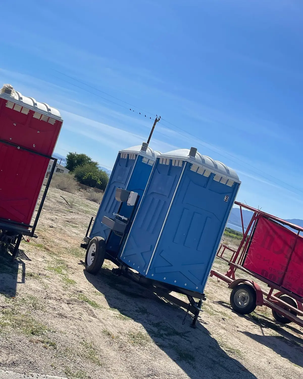 Two units on towable trailers ready to move with a crew